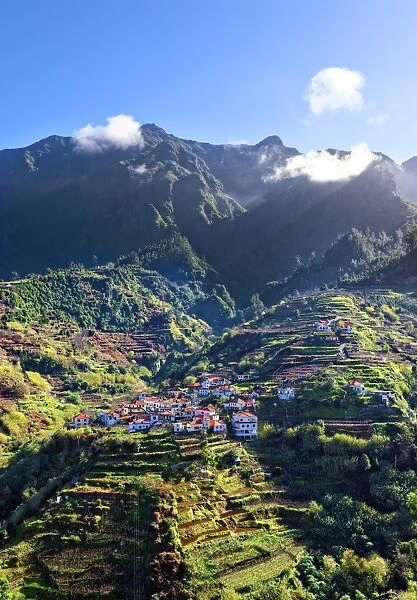 Elevated view of village and tree covered hills and mountains near Ponta Delgada