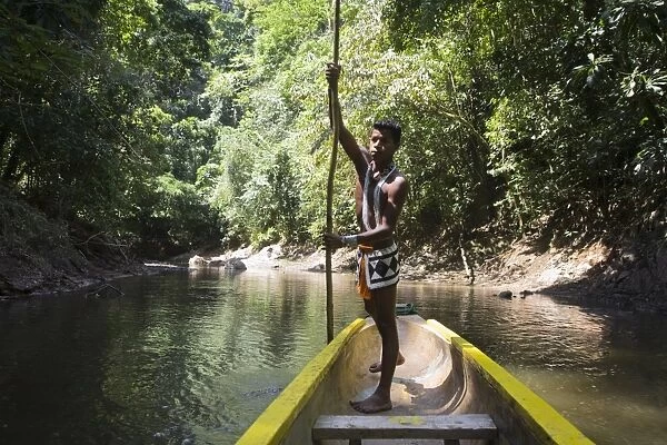 Embera Indian man in dugout canoe on Chagres River, Panama, Central America
