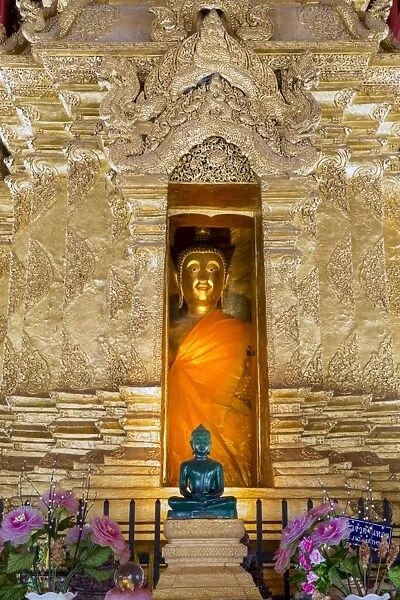 Emerald Buddha and golden Buddha in the main bot of historic Wat Phra That Lampang Luang temple
