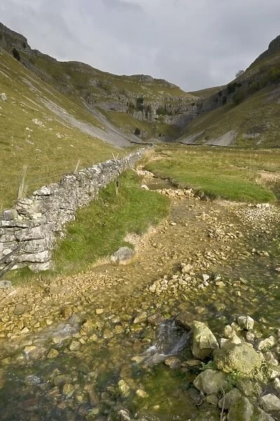 Entrance to Malham Cove with threatening clouds overhead, Yorkshire, England