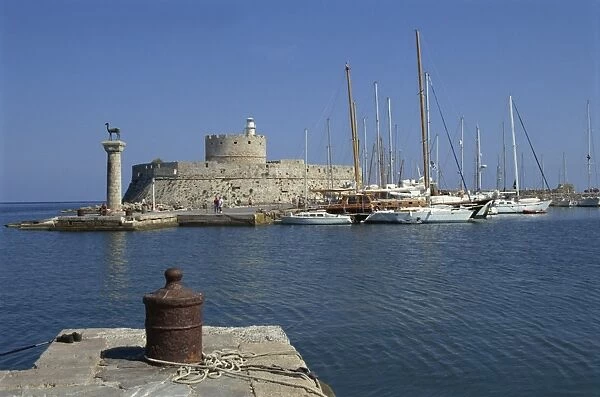 The entrance to Mandraki Harbour, with one of the buck statues and St