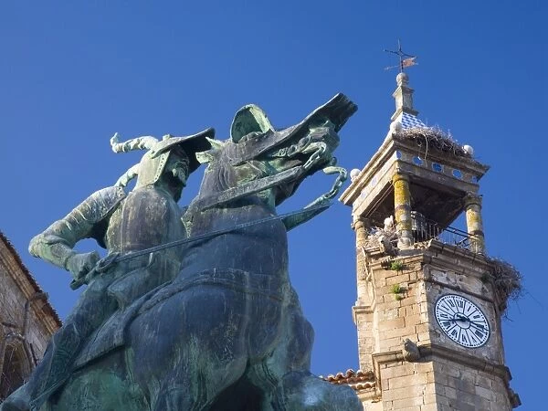 Equestrian statue of Francisco Pizarro in the Plaza Mayor, clock-tower of the Iglesia de San Martin beyond, Trujillo, Caceres, Extremadura