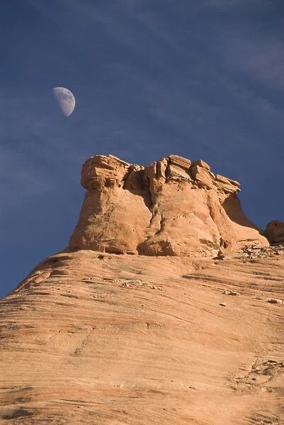 Eroded rock formations with moon in the sky, Mystery Valley, Monument Valley Navajo Tribal Park