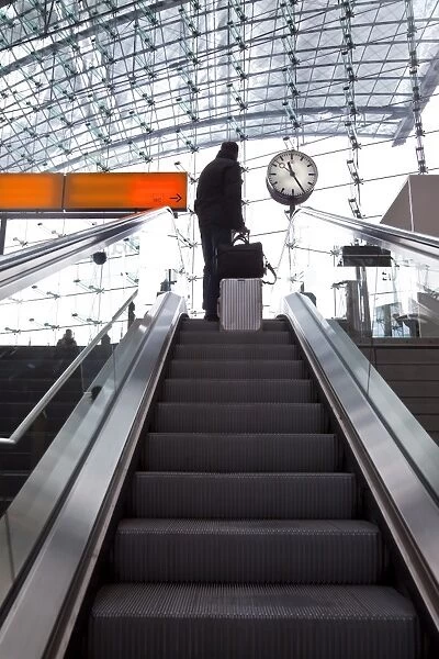 Escalator and platform clock at modern train station, Berlin, Germany, Europe