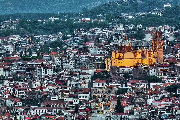 Evening overview, with illuminated Church of Santa Prisca de Taxco, Taxco, Guerrero, Mexico, North America