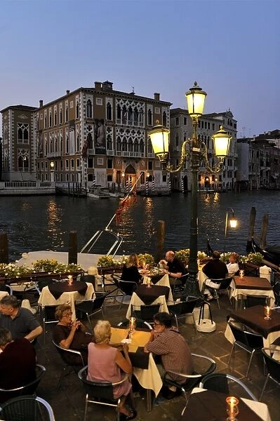 Evening view of a restaurant beside the Grand Canal, Venice UNESCO World Heritage Site