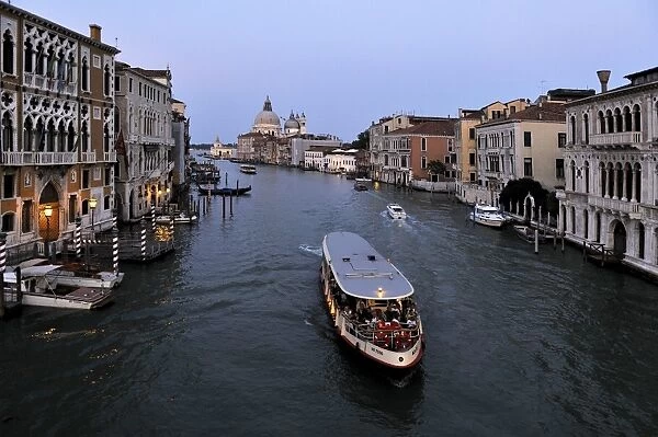 Evening view of a vaporetto (water bus) on the Grand Canal, Venice, UNESCO World Heritage Site