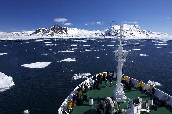 Expedition cruise vessel in Hornesund Fjord in summer sunshine, Spitzbergen