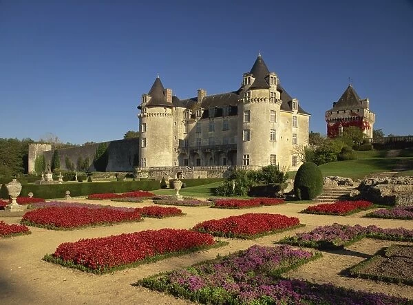 Exterior of Chateau Rochecourbon and colourful flowerbeds in formal gardens