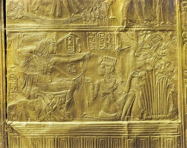 Detail of the exterior of the gilt shrine showing the queen helping the king in a ritual hunting scene, from the tomb of the pharaoh Tutankhamun, discovered in the Valley of the Kings, Thebes, Egypt, North