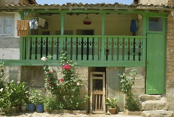 Detail of the exterior of a house with a green door and woodwork
