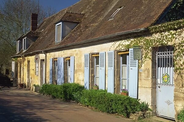 Exterior of a row of houses with pale blue doors and shutters, Aisne, St