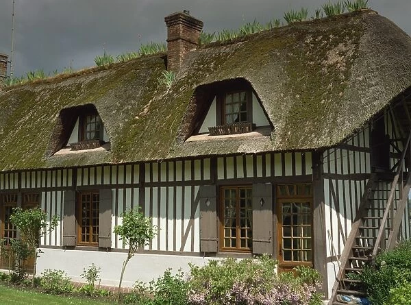 Exterior of a traditional timbered and thatched cottage in Vieux Port near Rouen in Haute Normandie (Normandy)
