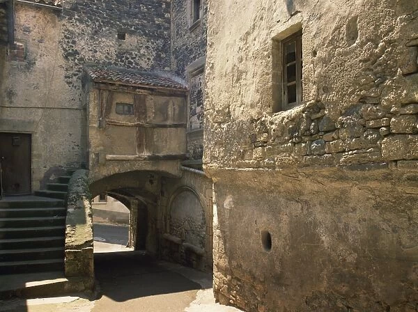 Exterior of village houses and arch on a street in St. Saturnin in the Auvergne