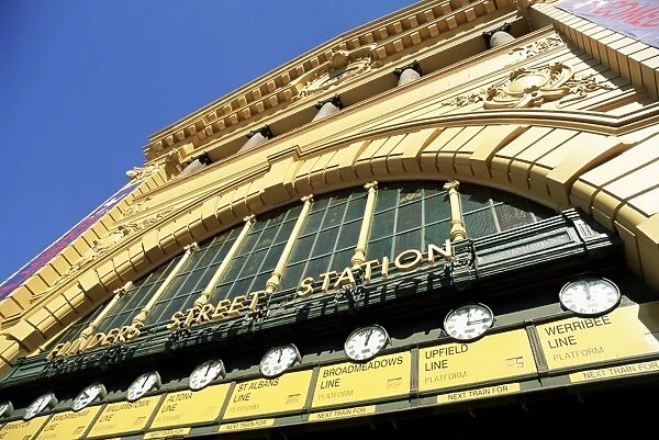 Facade of front of Flinders Street station with clocks showing department of next train