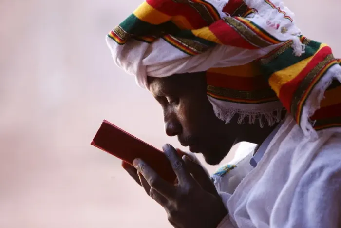 Framed Print : Faithful kissing a Bible outside a church in Lalibela, Ethiopia, Africa Framed Print : Faithful kissing a Bible outside a church in Lalibela, Ethiopia, Africa