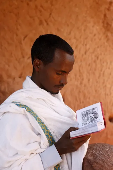 Framed Print : Faithful reading outside a church in Lalibela, Ethiopia, Africa Framed Print : Faithful reading outside a church in Lalibela, Ethiopia, Africa