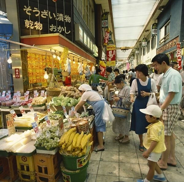 Family shopping in a covered market in Tokyo