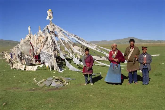 Framed Print : A family standing beside prayer flags at Huashixia in Qinghai, China, Asia Framed Print : A family standing beside prayer flags at Huashixia in Qinghai, China, Asia