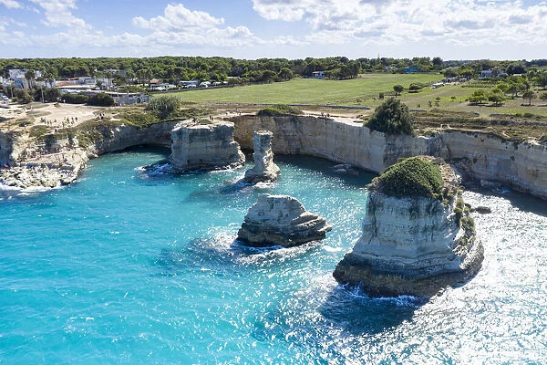 Faraglioni of Torre Sant Andrea and cliffs framed by turquoise sea, Lecce province