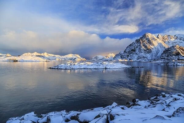 The feeble light of the sunset on a fjord near Henningsvaer covered in snow, Lofoten Islands, Arctic, Norway, Scandinavia, Europe