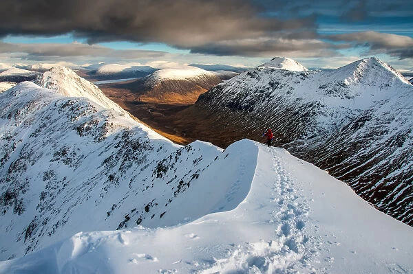 A female walker approaching the summit of Stob Dubh on Buchaille Etive Beag on a