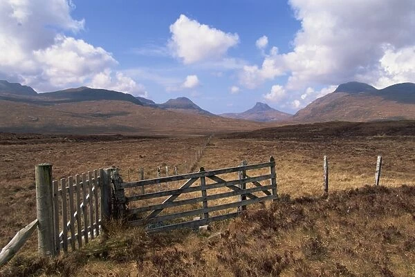 Fence and gate with mountains beyond