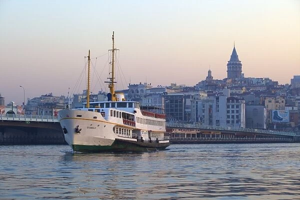 Ferry boat in Golden Horn with Galata Tower in background, Istanbul, Turkey, Europe