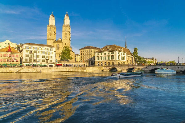 Ferry along Limmat River next to Munsterbrucke bridge with Grossmunster in background