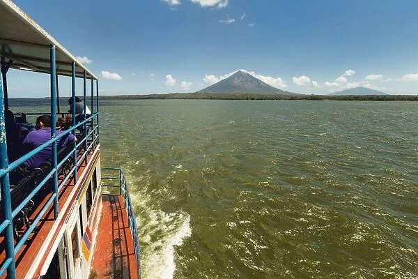 Ferry and the twin peaks of Omotepe Islands volcanoes Concepcion on left and Maderas, Isla Omotepe, Lake Nicaragua, Nicaragua, Central America