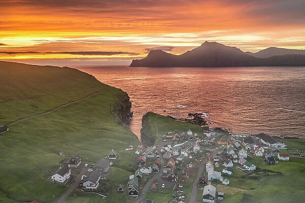 Fiery sky at dawn over Kalsoy island and the village of Gjogv, overhead view, Eysturoy Island, Faroe Islands, Denmark, Europe