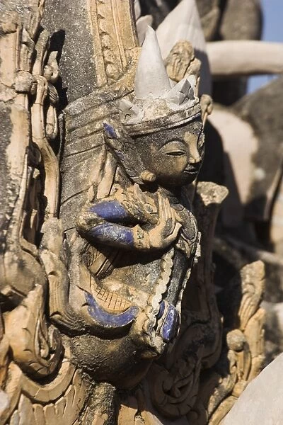 Figure carved in stucco decorates one of the ancient stupas, Kakku Buddhist Ruins