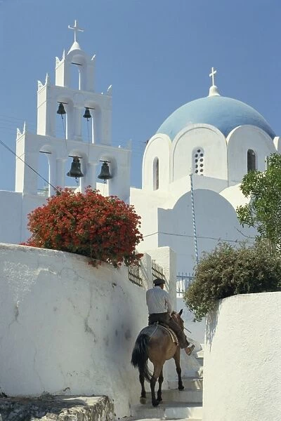 Figure on donkey passing church bell tower and dome