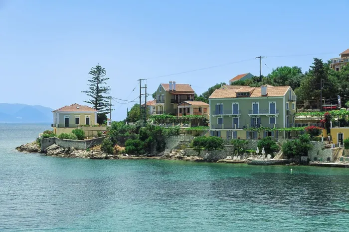 Framed Print : Fiscardo village of low rise houses with red tiled rooftops by a beach with bathers, Fiscardo, Kefalonia, Ionian Island, Greek Islands, Greece, Europe Framed Print : Fiscardo village of low rise houses with red tiled rooftops by a beach with bathers, Fiscardo, Kefalonia, Ionian Island, Greek Islands, Greece, Europe