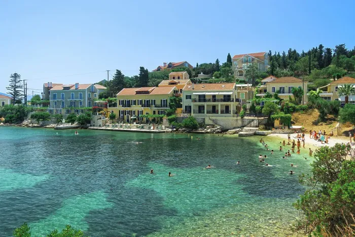 Framed Print : Fiscardo village of low rise houses with red tiles rooftops by a beach with bathers, Fiscardo, Kefalonia, Ionian Island, Greek Islands, Greece, Europe Framed Print : Fiscardo village of low rise houses with red tiles rooftops by a beach with bathers, Fiscardo, Kefalonia, Ionian Island, Greek Islands, Greece, Europe