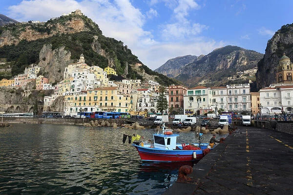 Fisherman in fishing boat and Amalfi town, Costiera Amalfitana (Amalfi Coast), UNESCO