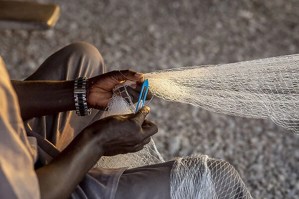Fisherman mending nets in Fadiouth, Senegal, West Africa, Africa