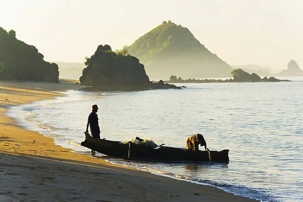 Fisherman returning to Kuta Beach with his daily catch, Kuta Lombok, Indonesia, Southeast Asia, Asia