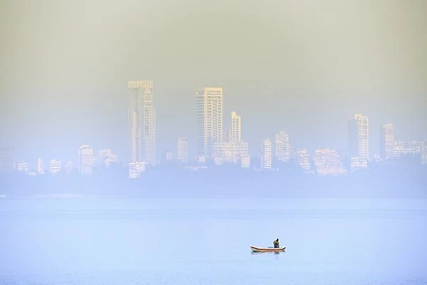 A fisherman in front of the skyscrapers of the Malabar Hills in Mumbai (Bombay), Maharashtra