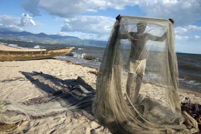 Framed Print : A fisherman tends his nets on Plage des Cocotiers (Coconut Beach) also known as Saga Beach Framed Print : A fisherman tends his nets on Plage des Cocotiers (Coconut Beach) also known as Saga Beach