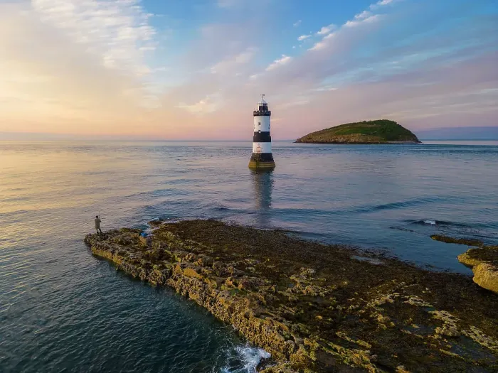 Framed Print : Fisherman at Trwyn Du Lighthouse at sunset in summer, Beaumaris, Wales, Great Britain, United Kingdom, Europe Framed Print : Fisherman at Trwyn Du Lighthouse at sunset in summer, Beaumaris, Wales, Great Britain, United Kingdom, Europe