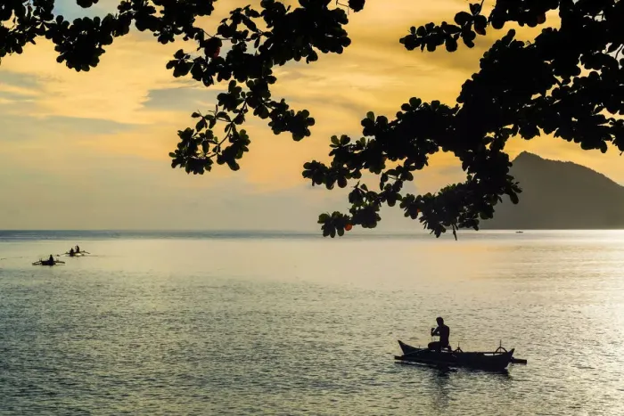 Framed Print : Fishermen paddle outrigger canoes at sunset off Kalea Beach, Kalea, Siau Island, Sangihe Archipelago, North Sulawesi, Indonesia, Southeast Asia, Asia