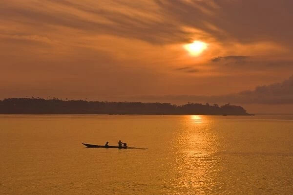 Fishermen at sunset on the Amazon River, Brazil, South America