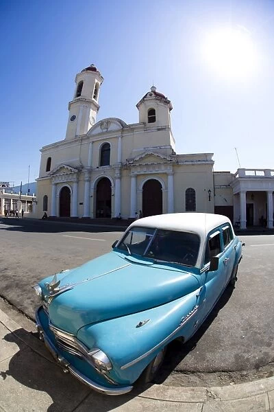 Fisheye image of vintage American car and church, Parc Jose Marti, Cienfuegos, UNESCO World Heritage Site, Cuba, West Indies, Central America