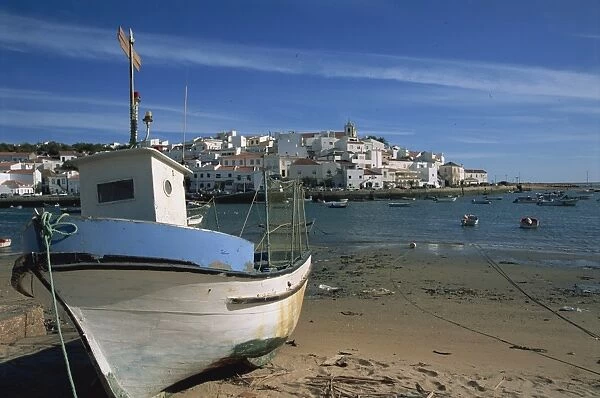 Fishing boat on the beach in small fishing village near Portimao