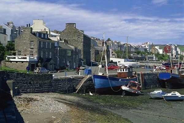 Fishing boat dried out in the Old Harbour, Port St. Mary, Isle of Man, United Kingdom