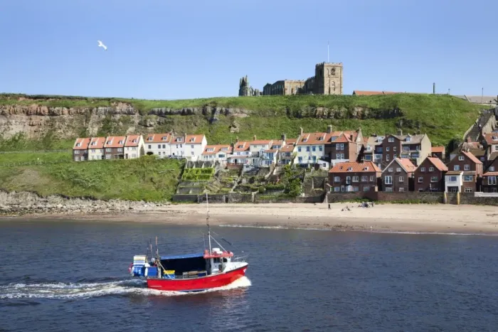 Framed Print : Fishing boat entering the harbour below Whitby Abbey, Whitby, North Yorkshire, Yorkshire, England, United Kingdom, Europe