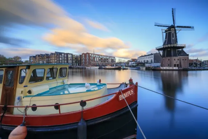 Framed Print : The fishing boat frames the Windmill De Adriaan reflected in the River Spaarne at dusk Framed Print : The fishing boat frames the Windmill De Adriaan reflected in the River Spaarne at dusk