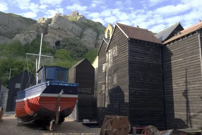 Framed Print : Fishing boat and historic buildings with Hastings Castle in the background