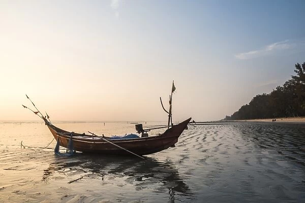 Fishing boat on Maungmagan Beach at sunset, Dawei, Tanintharyi Region, Myanmar (Burma)